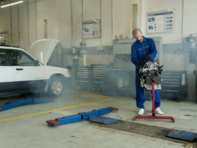 Technician working on performance engine modifications in shop